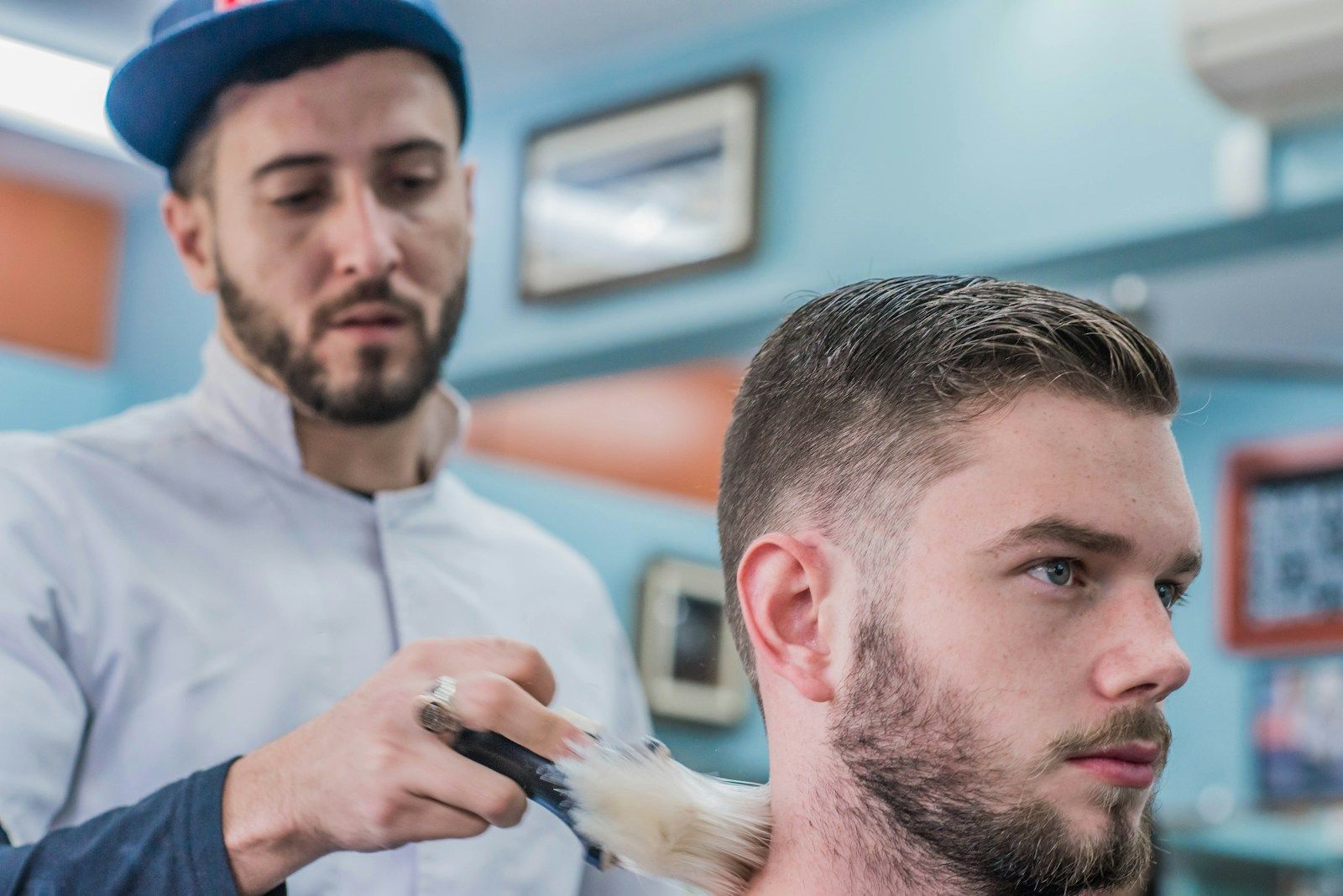 Barber at work, carefully shaping a client’s hair