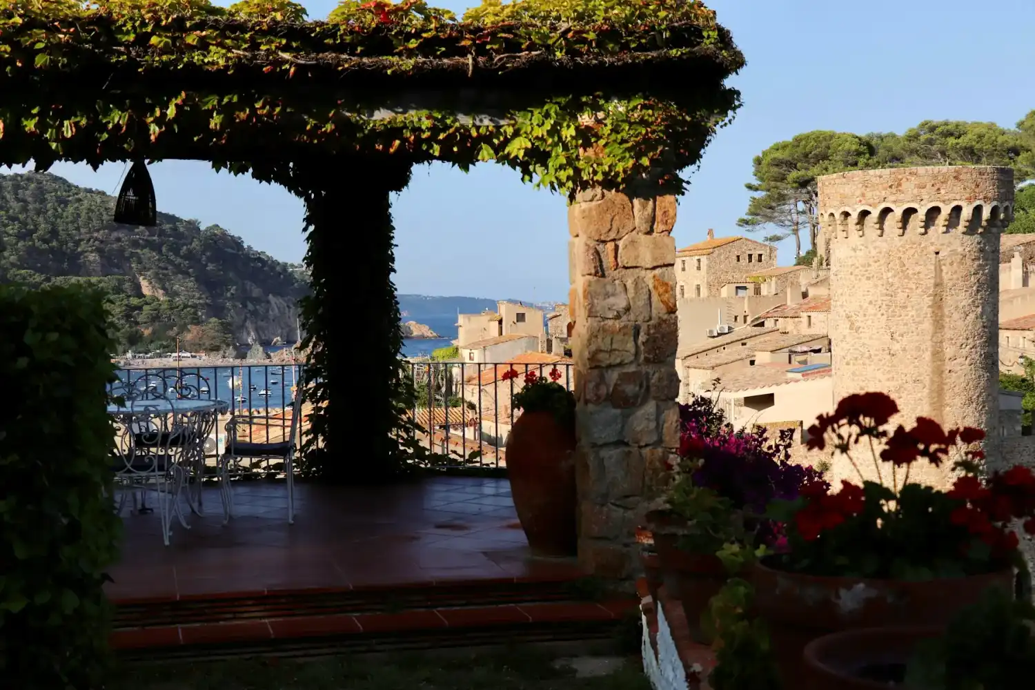 The Costa Brava sea and Tossa de Mar, seen from a stone-arched terrace